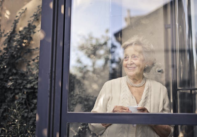 female resident looking out the window smiling