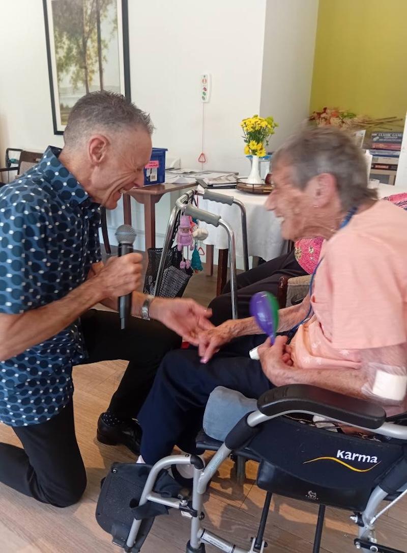 resident and entertainer holding hands