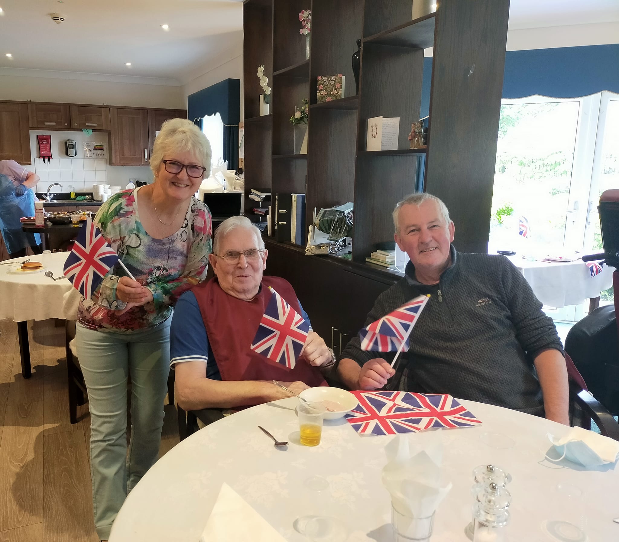 A resident and his loved ones waving the Union Jack flag.