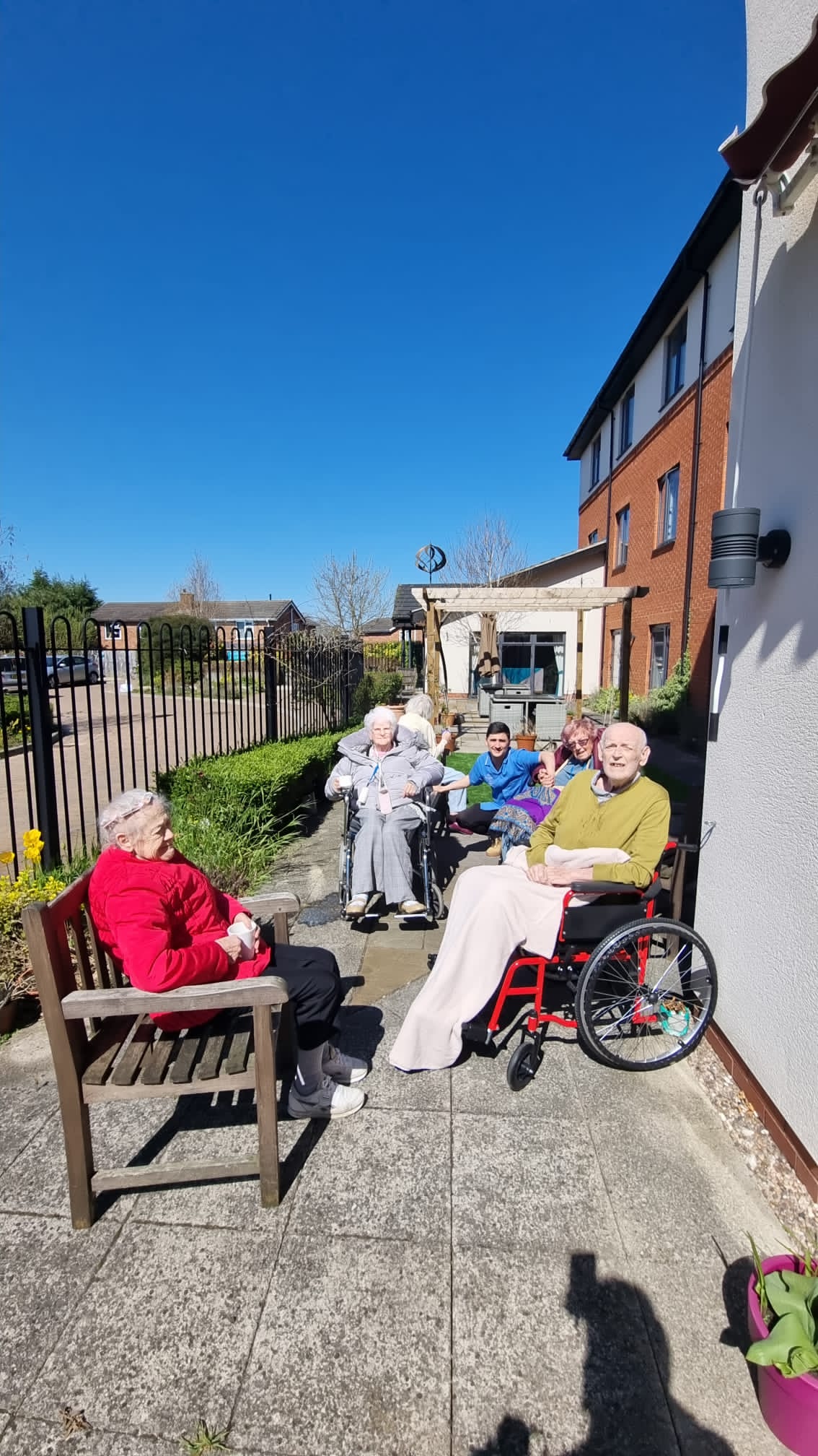 The Ashton Care Home residents in the garden enjoying the sun and clear skies.