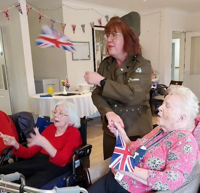 our residents waving flags and singing on VE day