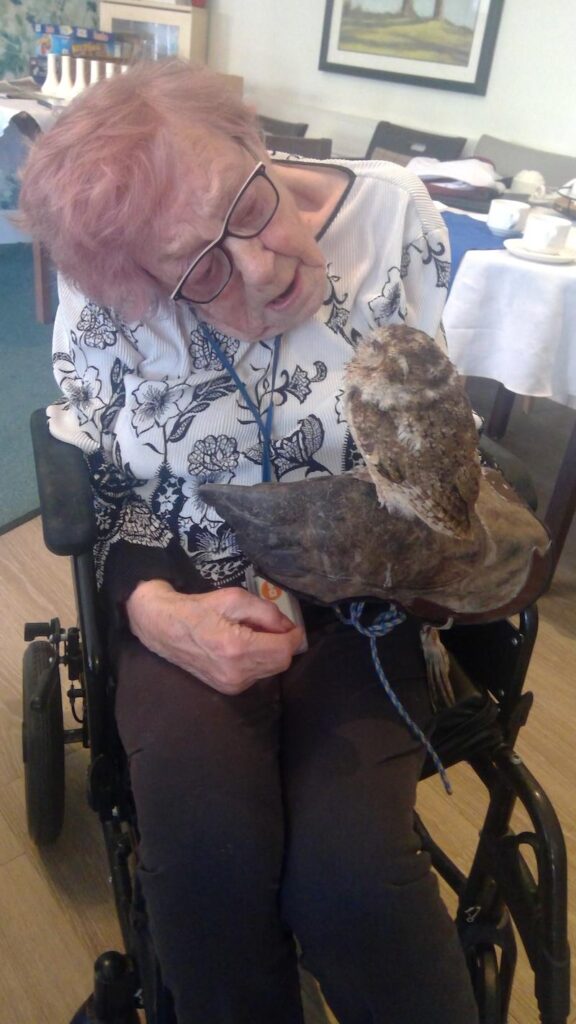 female resident with an owl on her arm