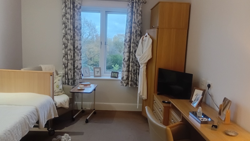 One of our bedrooms at the ashton with a wardrobe, dresser, desk and bed