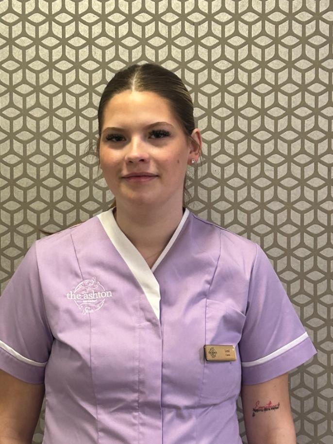 girl with hair tied back posing for staff photo