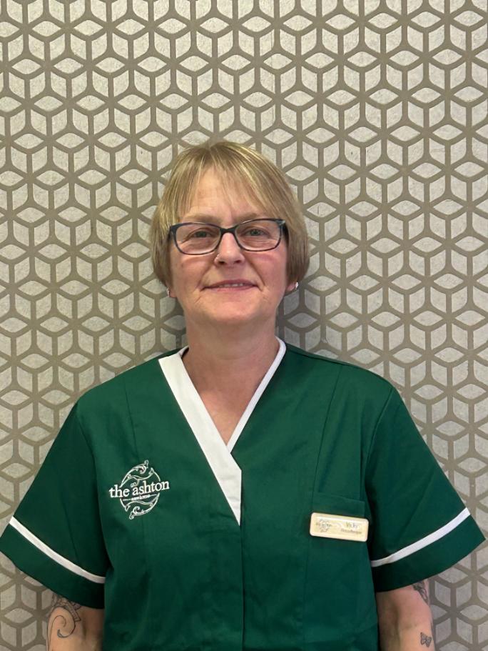 lady with glasses posing for staff photo