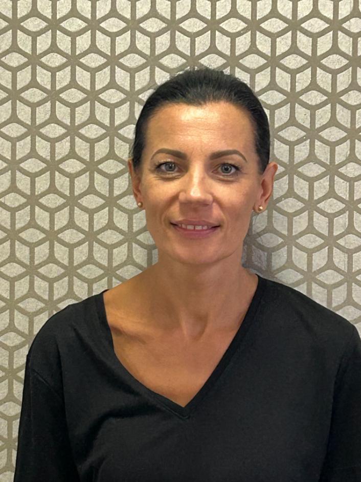 lady smiling at camera for staff photo
