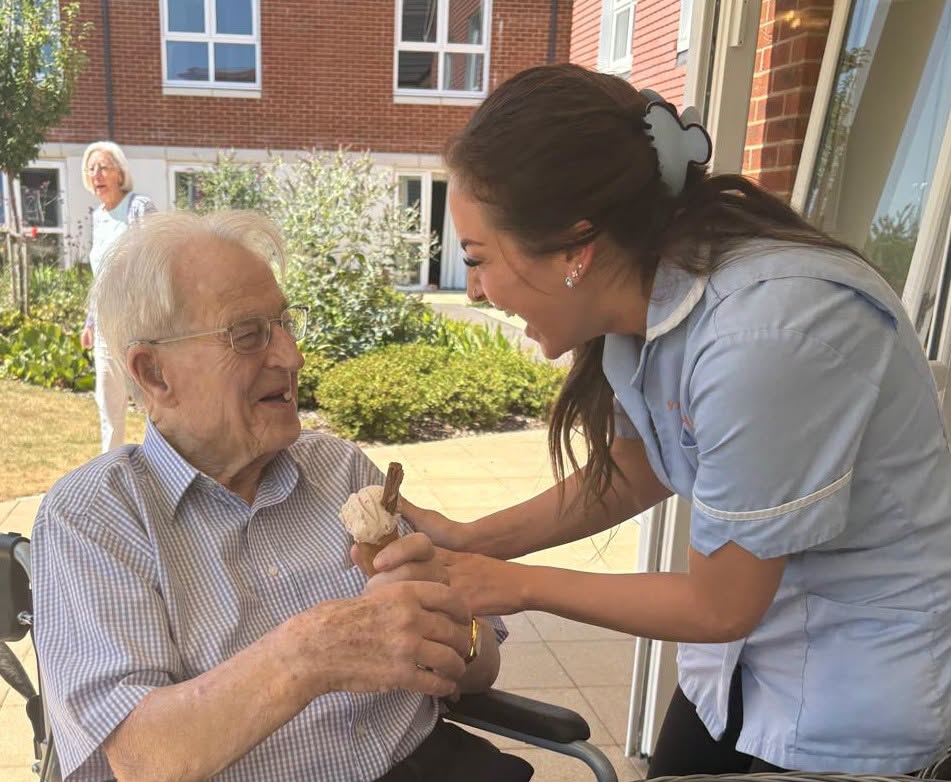 a carer giving an older man an ice cream