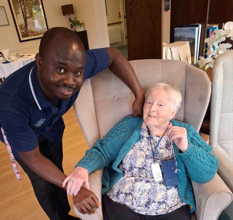 nurse and resident smiling